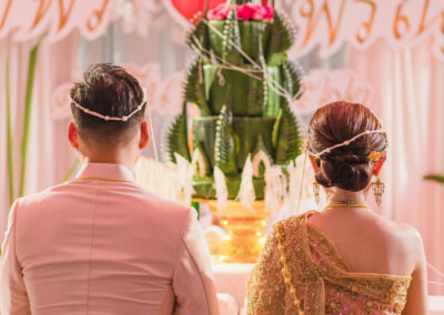 Rear view of the bride and groom in a Thai style wedding ceremony.